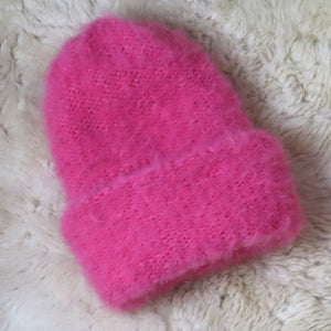 A furry hat with a twist brim
